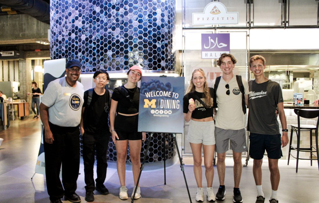 Students standing at the entrance of South Quad's dining hall