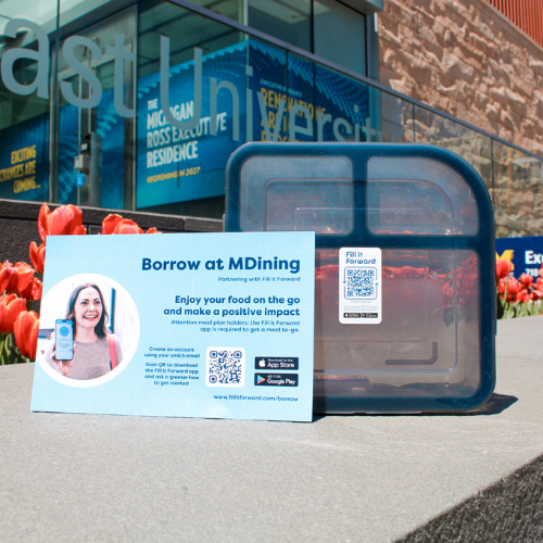 to-go box with a fill it forward app on a post card